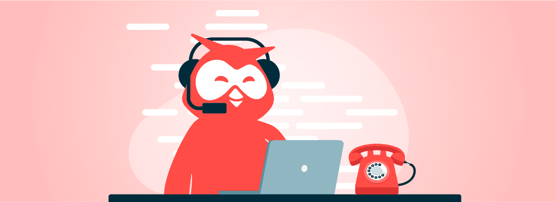 Owly wearing headset working on laptop with retro red telephone nearby, against pink background